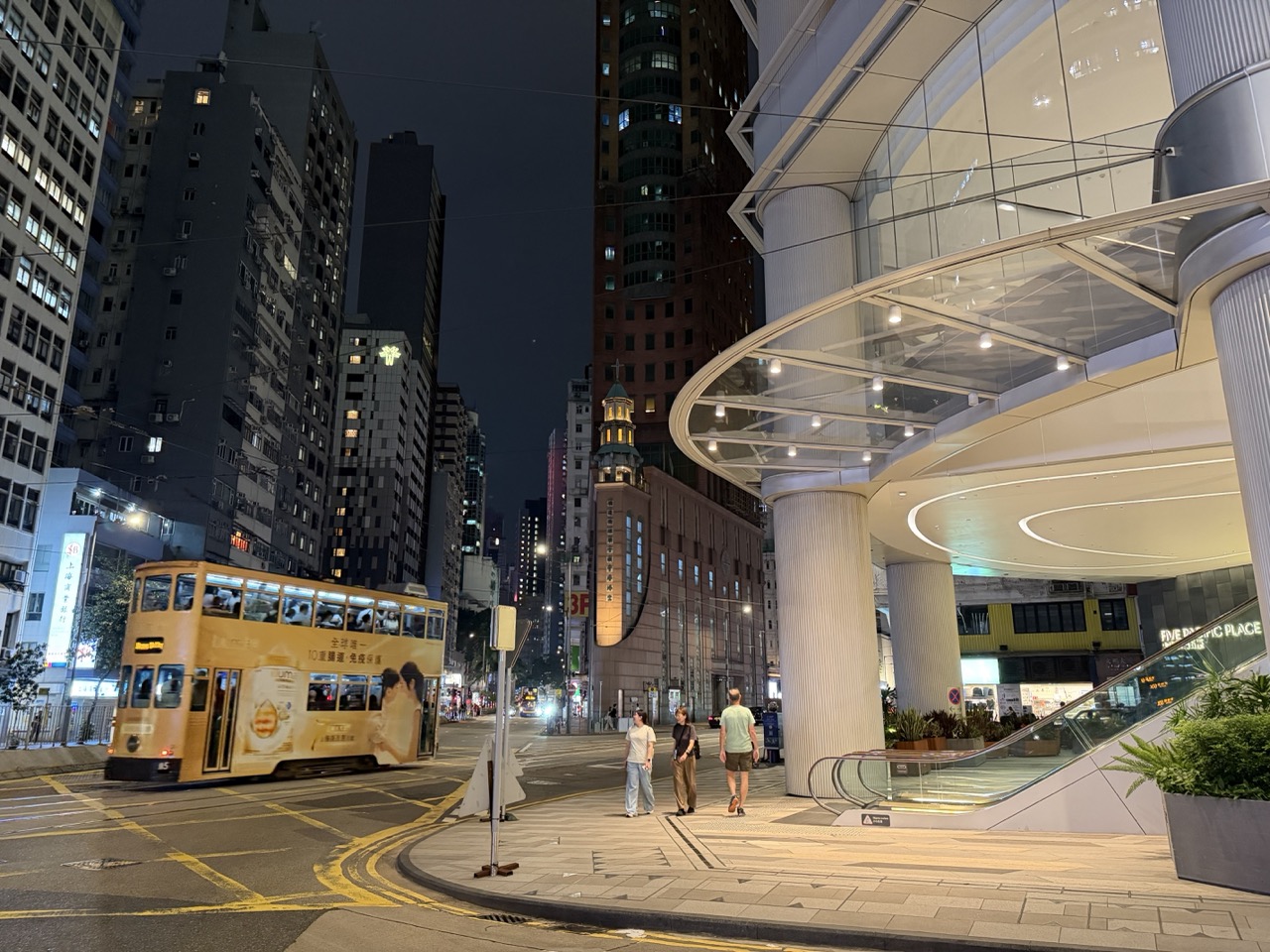 A tram passing Five Pacific Place in Wan Chai at night
